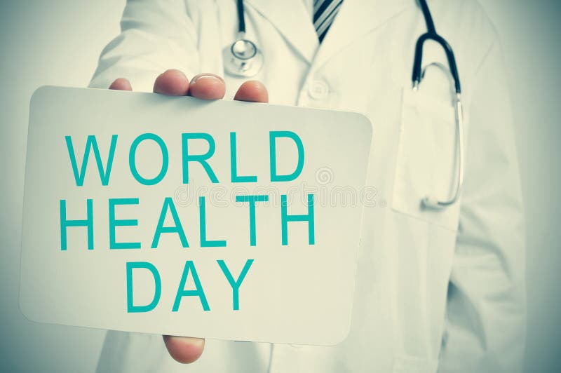 Doctor shows a signboard with the text world health day royalty free stock photos Doctor shows a signboard with the text world health day royalty free stock photos