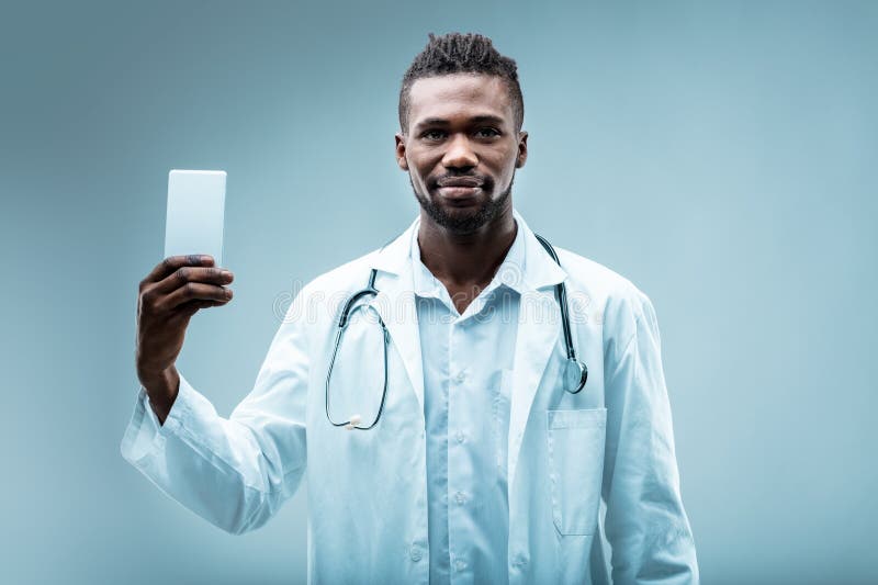 Doctor shows smartphone for quick health aid royalty free stock photo