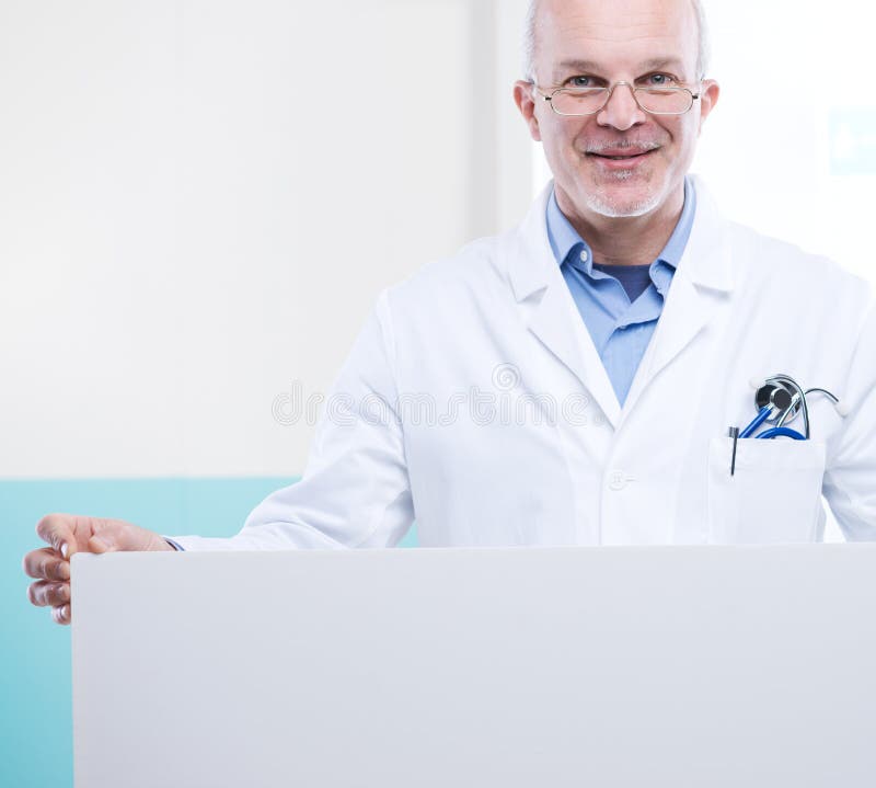 Doctor holding a big white sign with blank copy space. Doctor holding a big white sign with blank copy space.