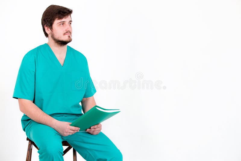 The Doctor Sits on a Chair with Folder on a White Background. Stock