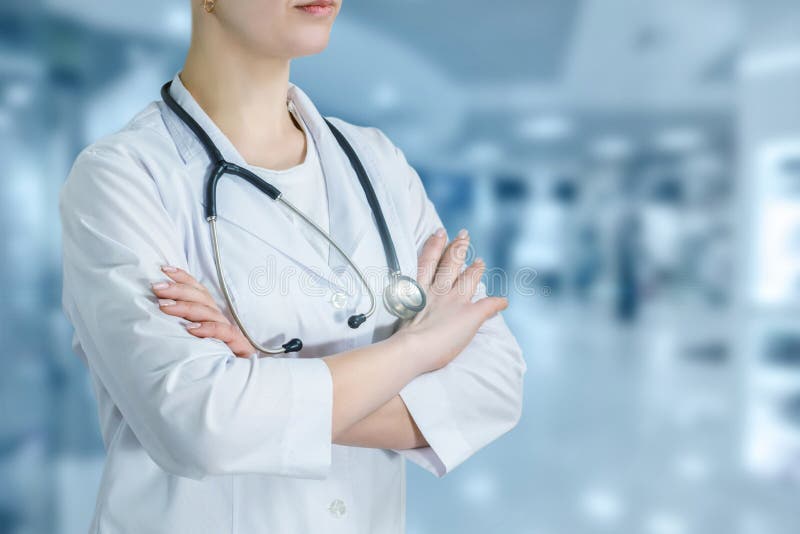 A doctor standing in the hospital hall with crossed hands royalty free stock photo A doctor standing in the hospital hall with crossed hands royalty free stock photo