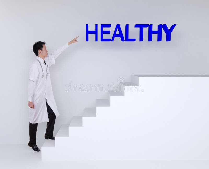 Male doctor stepping up on stairs and pointing to healthy