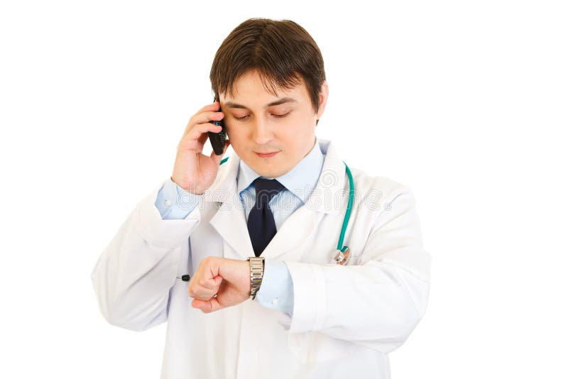 Doctor talking on mobile and looking at his watch stock photos Doctor talking on mobile and looking at his watch stock photos