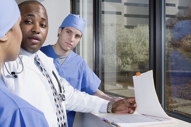 Doctor talking to surgeons royalty free stock photography