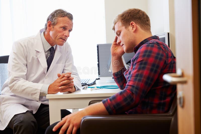 Doctor Treating Male Patient Suffering with Depression Stock Image