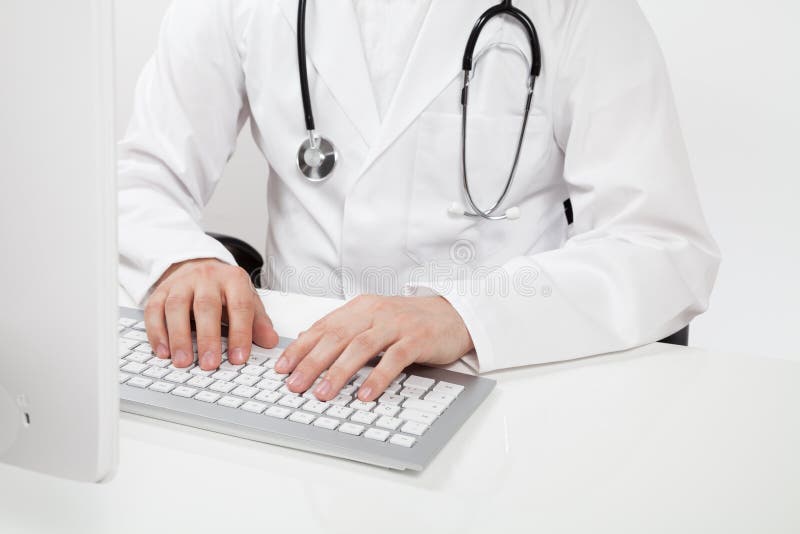 Doctor typing on computer stock photo