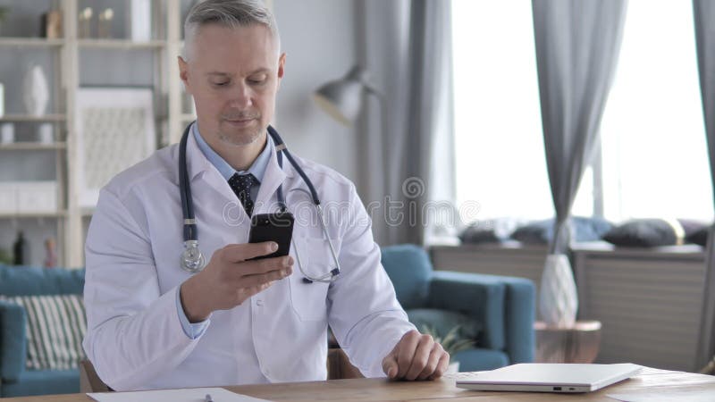 Doctor Typing Message on Phone stock footage