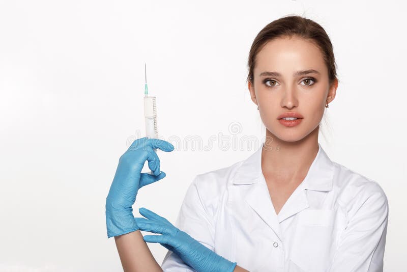 Doctor in uniform and gloves with syringe stock photography Doctor in uniform and gloves with syringe stock photography