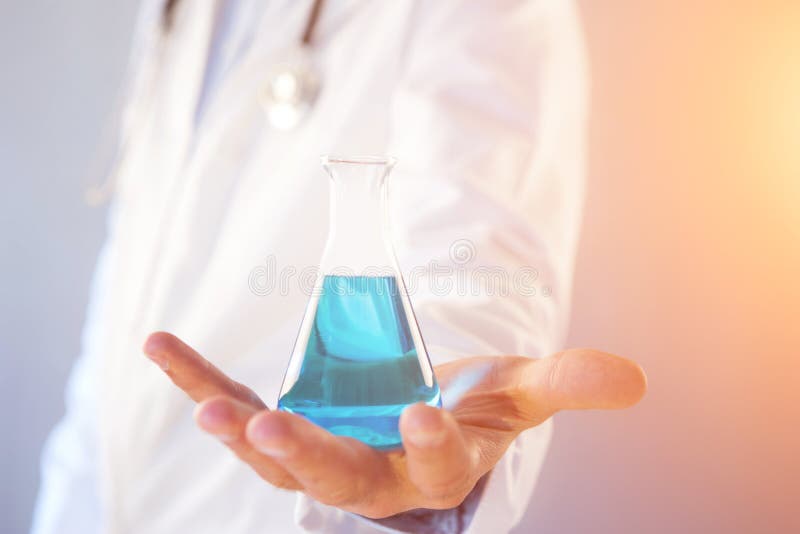 Doctor using flask on a color background royalty free stock images
