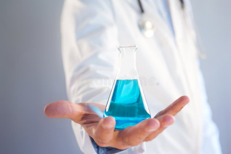 Doctor using flask on a color background royalty free stock image