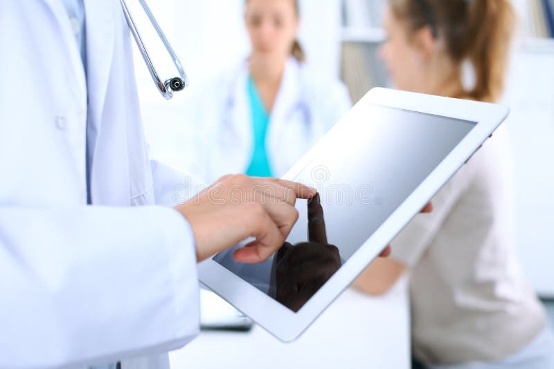 Doctor using tablet computer, close-up of hands at touch pad screen royalty free stock photography Doctor using tablet computer, close-up of hands at touch pad screen royalty free stock photography