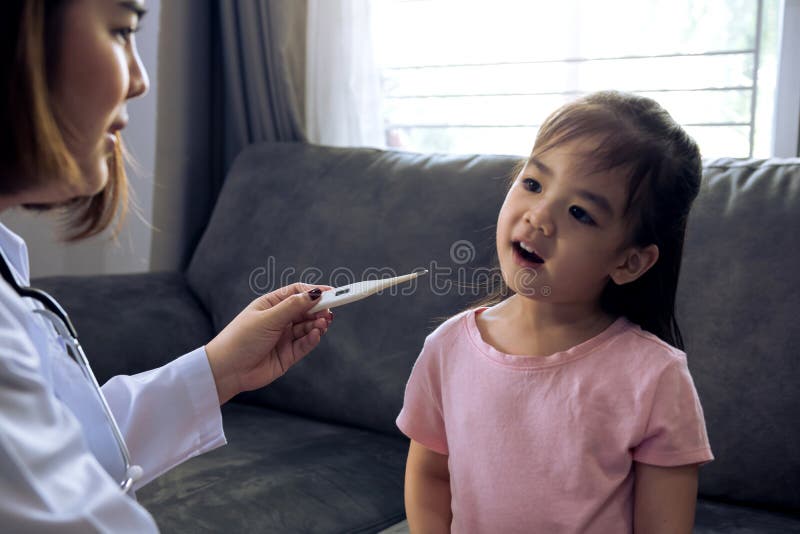 Doctor Using Temperature Child Patient in Home Stock Image Image of