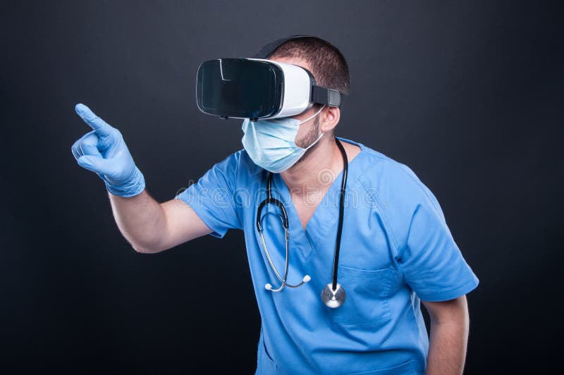 Doctor wearing scrubs using virtual reality glasses and touchscreen stock photography
