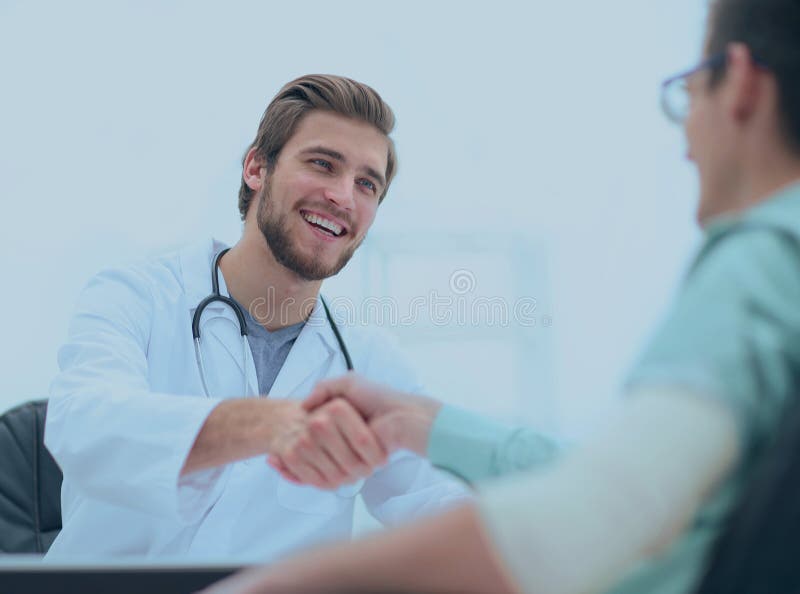 Doctor welcoming a patient in his studio stock photography Doctor welcoming a patient in his studio stock photography