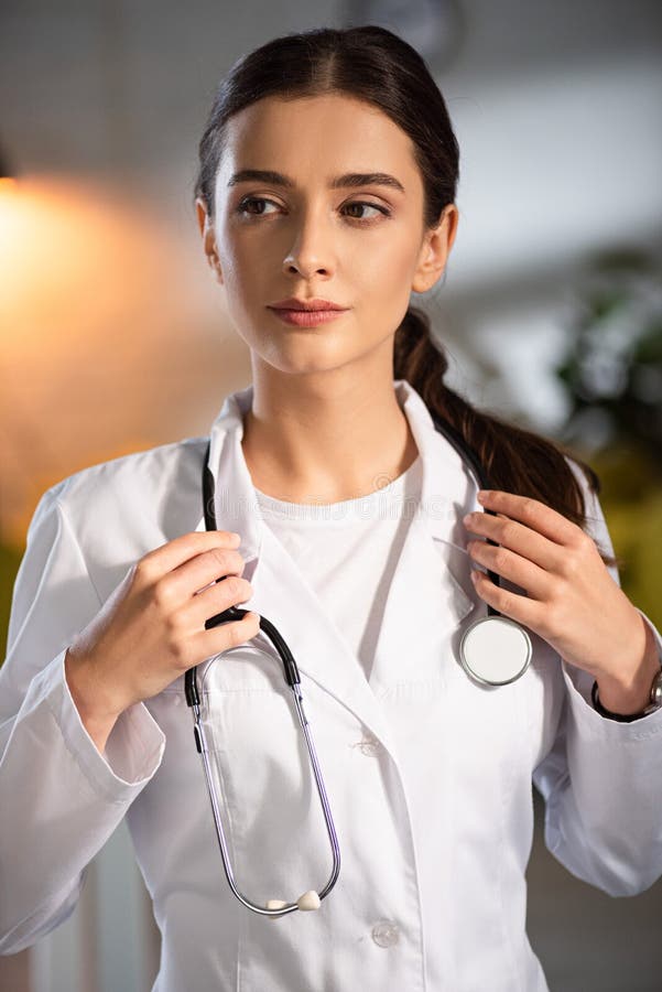 Doctor in White Coat Holding Stethoscope Stock Photo Image of indoors