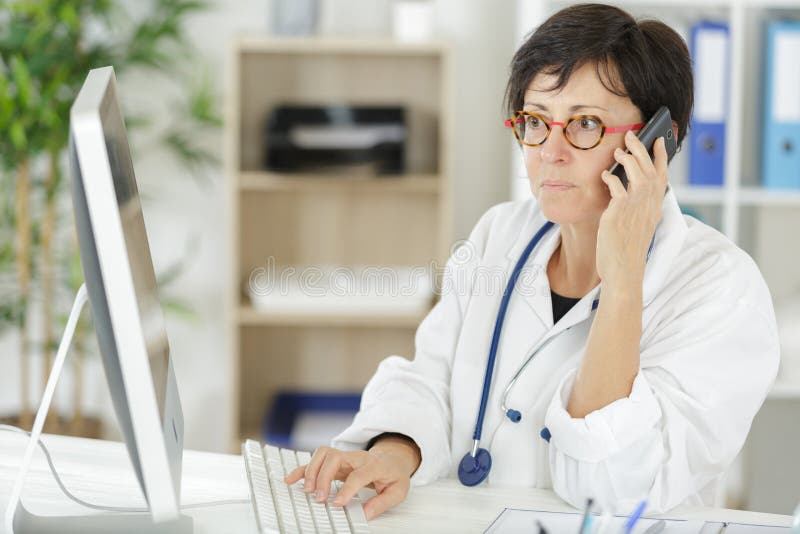 Doctor woman in medical office talking on phone