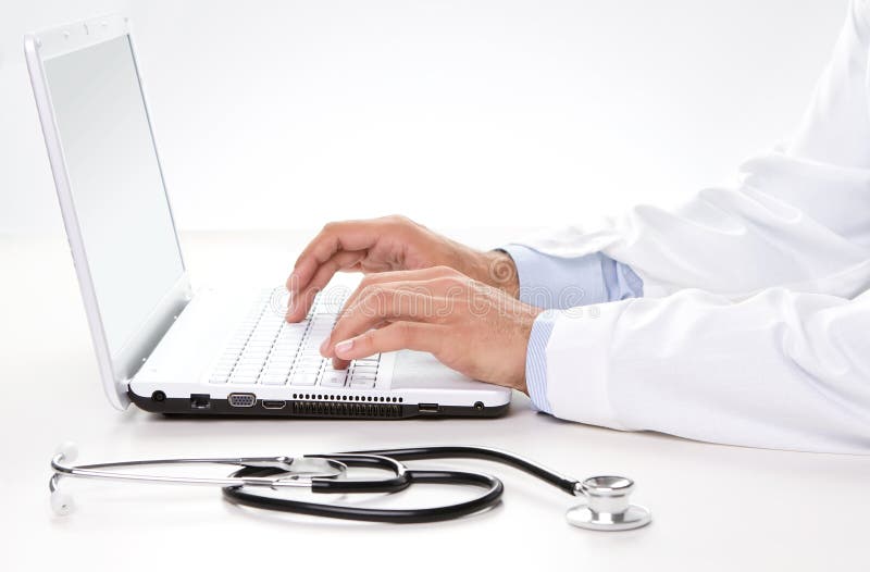 Doctor working on a laptop stock images