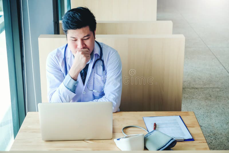 Doctor is working in office sitting, thinking about Disease problem of patient royalty free stock photos Doctor is working in office sitting, thinking about Disease problem of patient royalty free stock photos