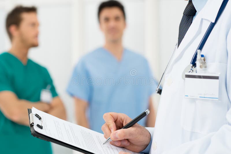 Doctor Writing On A Clipboard stock image
