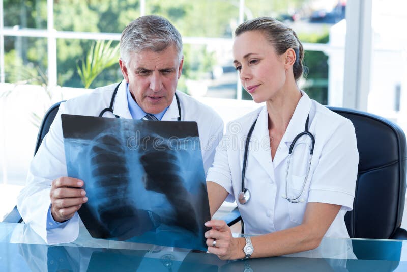 Doctors looking together at xray royalty free stock images Doctors looking together at xray royalty free stock images