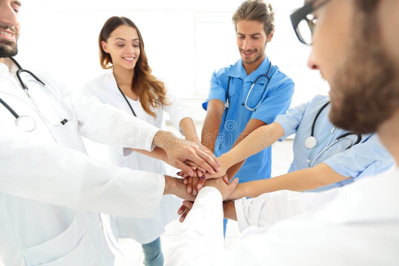 Doctors and nurses in a medical team stacking hands. concept of unity. Diverse medical team stock images, royalty-free photos and pictures