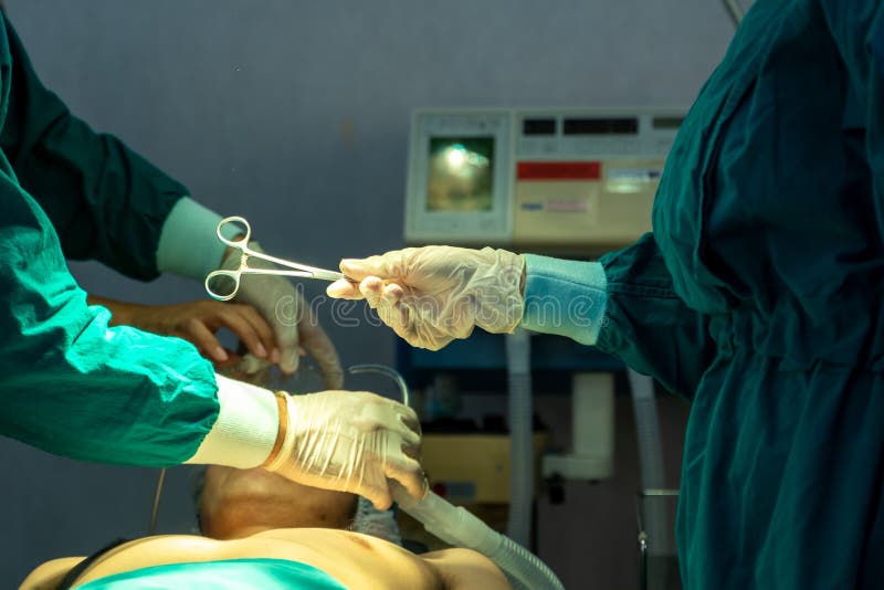 Doctors with Surgery Team Operating in a Surgical Room Stock Image