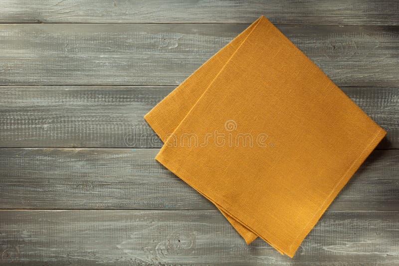 Cloth napkin on wooden table background. Cloth napkin on wooden table background