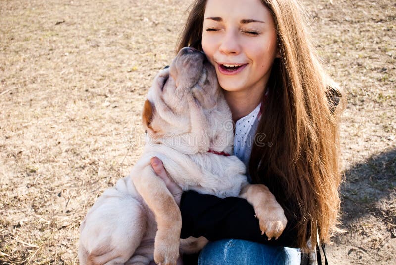 Dog licks her mistress