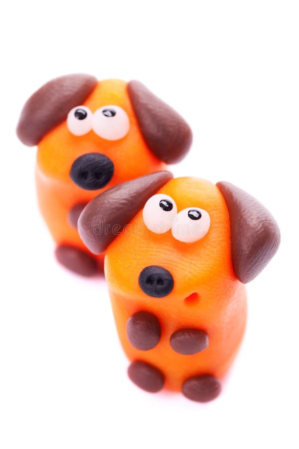 Orange dogs made of polymer clay isolated on white background