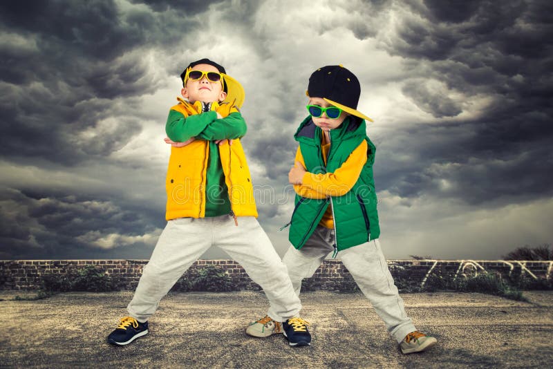 Children`s fashion.Two brothers dancing break dance.Hip-hop style.The cool kids. Children`s fashion.Two brothers dancing break dance.Hip-hop style.The cool kids.