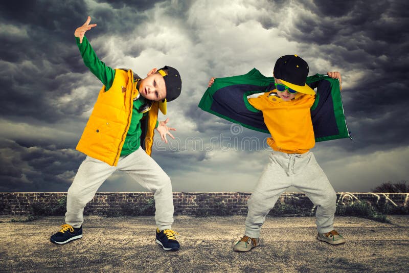 Children`s fashion.Two brothers dancing break dance.Hip-hop style.The cool kids. Children`s fashion.Two brothers dancing break dance.Hip-hop style.The cool kids.