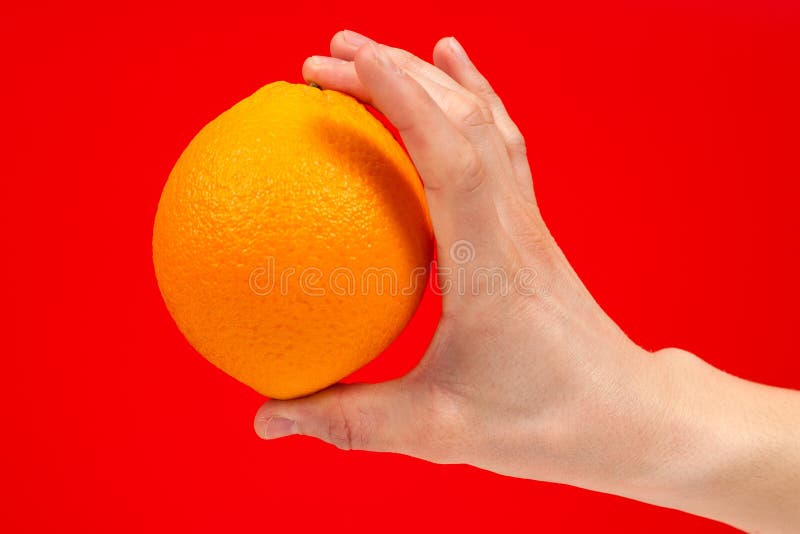 Dojrza?a soczysta wy?mienicie pomara?cze w r?ce odizolowywaj?cej na czerwonym tle Zdrowy ?asowanie i dieting poj?cie fotografia royalty free Dojrza?a soczysta wy?mienicie pomara?cze w r?ce odizolowywaj?cej na czerwonym tle Zdrowy ?asowanie i dieting poj?cie fotografia royalty free