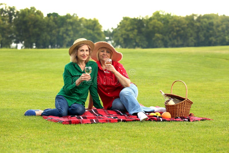 Mature women on a picnic in green park. Mature women on a picnic in green park