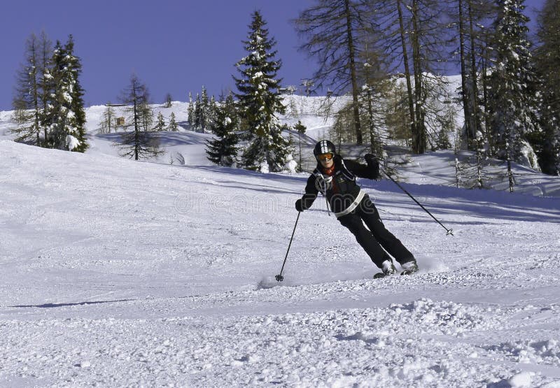 Mature women skiing downhill Shuttleberg in Kleinarl ski area, Austria. Mature women skiing downhill Shuttleberg in Kleinarl ski area, Austria