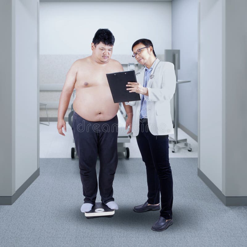 Doctor measuring the body mass of overweight men with weigher. Doctor measuring the body mass of overweight men with weigher