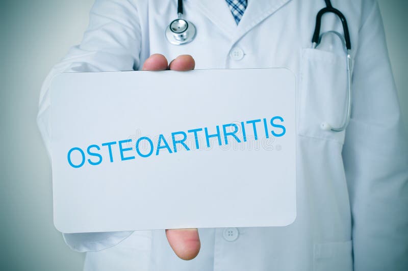 Closeup of a young caucasian doctor showing a signboard with the text osteoarthritis written in it. Closeup of a young caucasian doctor showing a signboard with the text osteoarthritis written in it