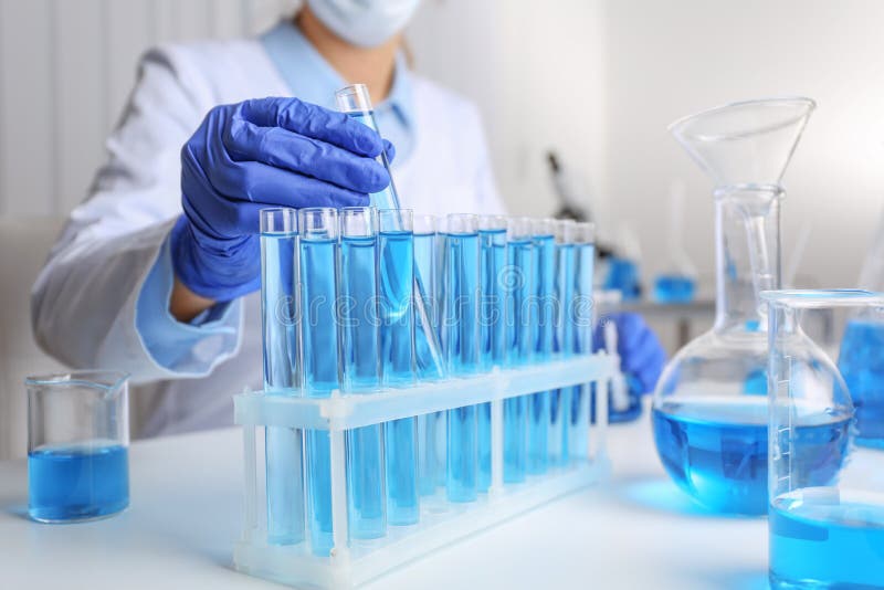 Doctor taking test tube with blue liquid, closeup. Laboratory analysis. Doctor taking test tube with blue liquid, closeup. Laboratory analysis