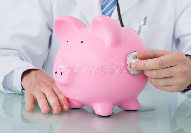 Doktor Untersuchungspiggybank mit Stethoskop stockfotografie Doktor Untersuchungspiggybank mit Stethoskop stockfotografie