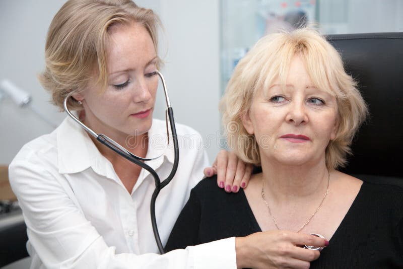 Young female doctor, examining patient. Young female doctor, examining patient