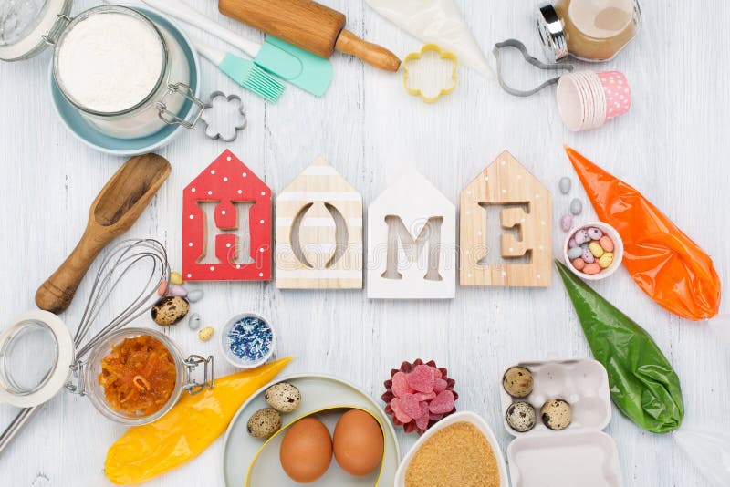 Sweet home baking concept for Easter. Cooking table with rolling pin, eggs, whisk for whipping, cookie cutters, sugar sprinkling, flour. Rustic white wooden background, top view copy space. Sweet home baking concept for Easter. Cooking table with rolling pin, eggs, whisk for whipping, cookie cutters, sugar sprinkling, flour. Rustic white wooden background, top view copy space