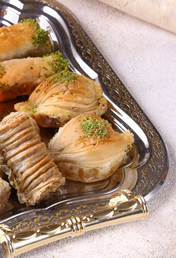 Turkish sweets baklava with nuts on a metal tray. Turkish sweets baklava with nuts on a metal tray