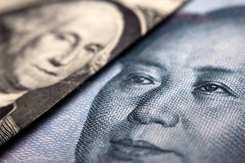 Close-up of an American dollar bill (showing George Washington) and a Chinese yuan banknote (Mao Zedong). Close-up of an American dollar bill (showing George Washington) and a Chinese yuan banknote (Mao Zedong)