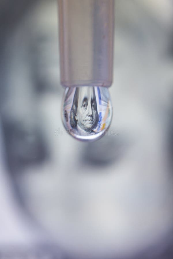 100 dollar bill reflects in a droplet. Money making by drops concept. Vertical