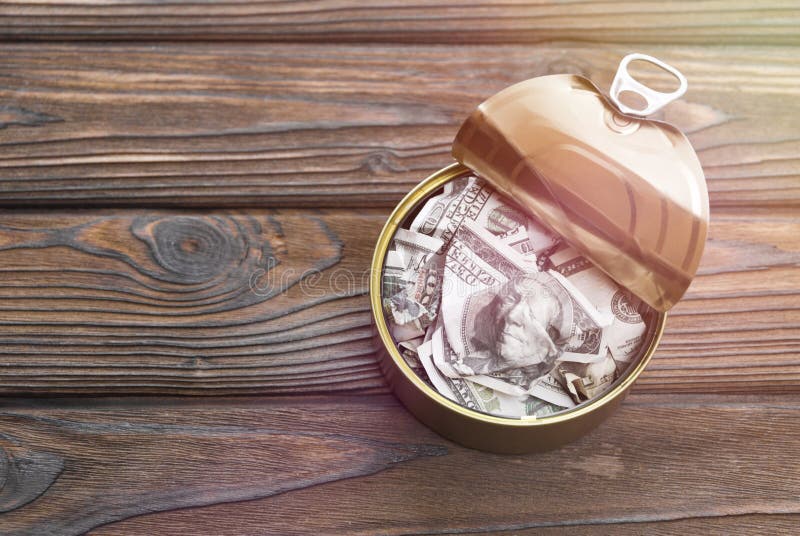Dollar bills in an iron can stock images