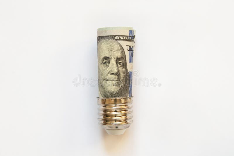 Dollar in a lamp socket on a white background, high price of electricity, price royalty free stock photos