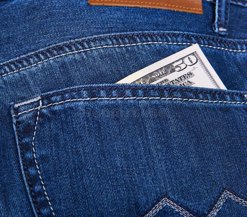 50 Dollars bill sticking out from a blue jean pocket. Closeup. 50 Dollars bill sticking out from a blue jean pocket. Closeup
