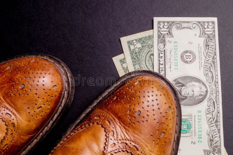https://thumbs.dreamstime.com/b/dollars-under-pair-shoes-business-money-cost-date-isolated-black-52733319.jpg