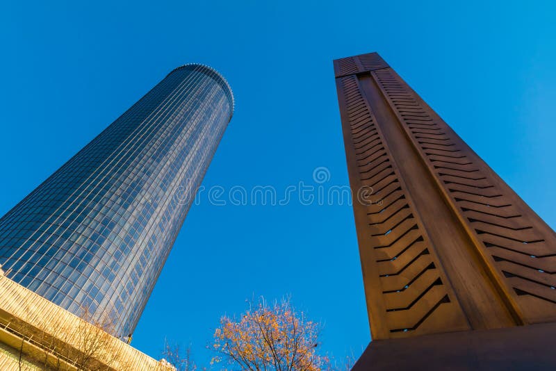 Bottom view of the skyscraper and the Andrew Young Obelisk on the background of clear sky, Atlanta, USA. Bottom view of the skyscraper and the Andrew Young Obelisk on the background of clear sky, Atlanta, USA