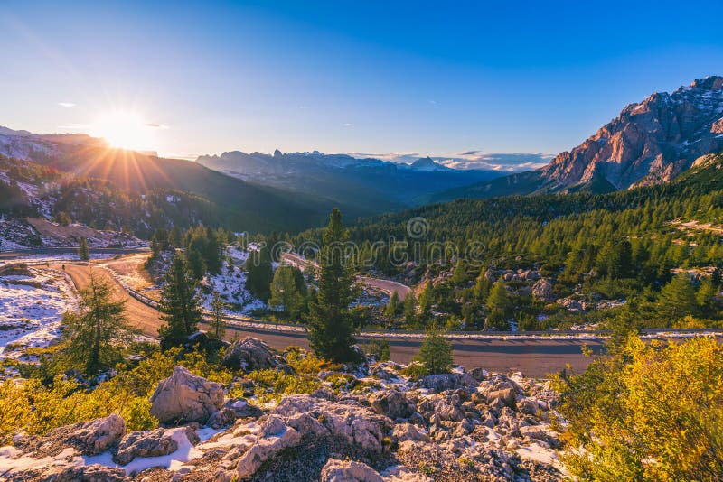 Dolomite Alps in Italy. Beautiful day. The road passes in the co stock photos Dolomite Alps in Italy. Beautiful day. The road passes in the co stock photos