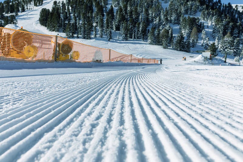 Dolomites, ski area with beautiful slopes. Empty ski slope in winter on a sunny day. Prepared piste and sunny day